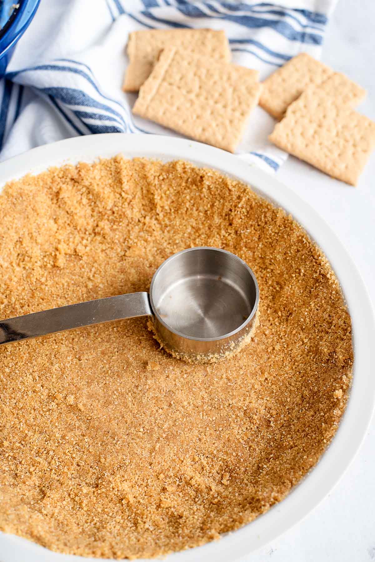 pressing crumbs to make pie crust