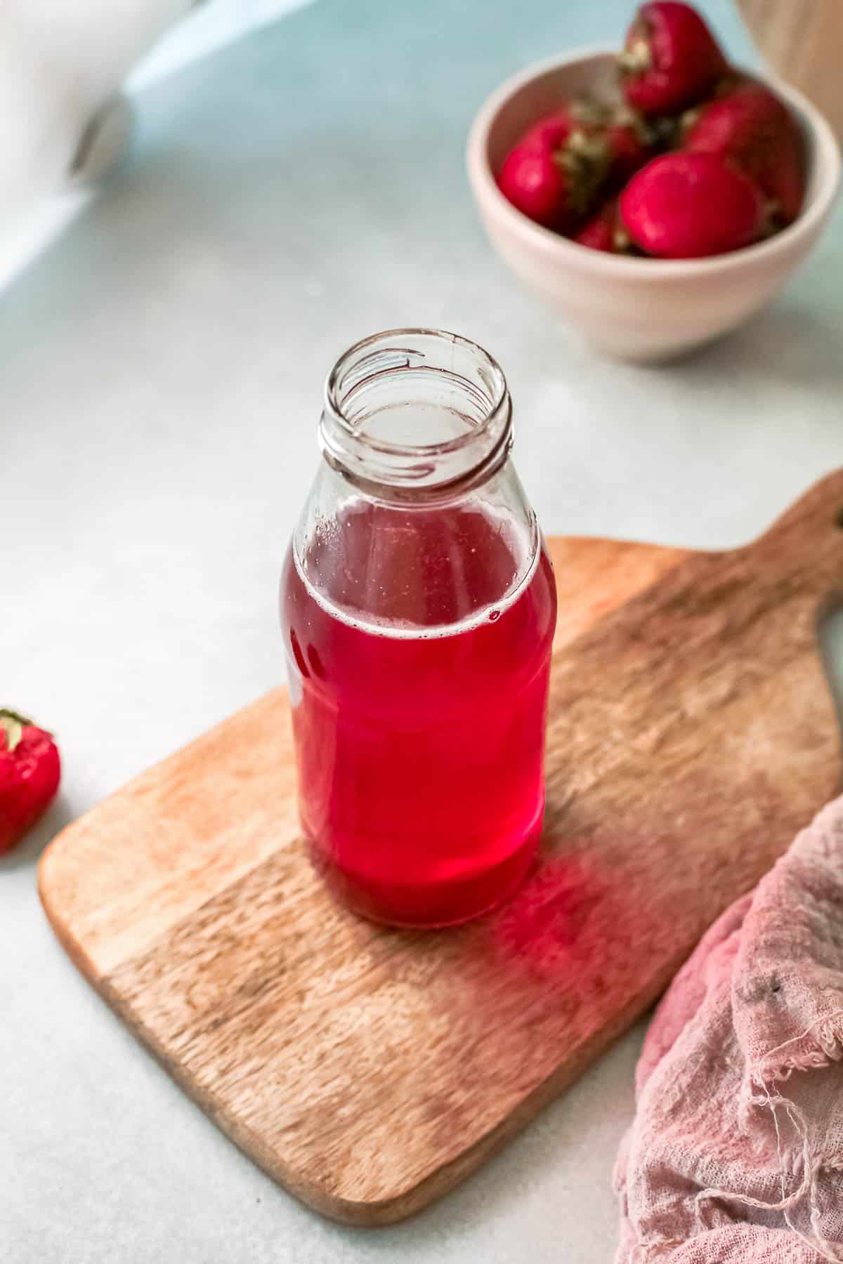 strawberry simple syrup in bottle from above