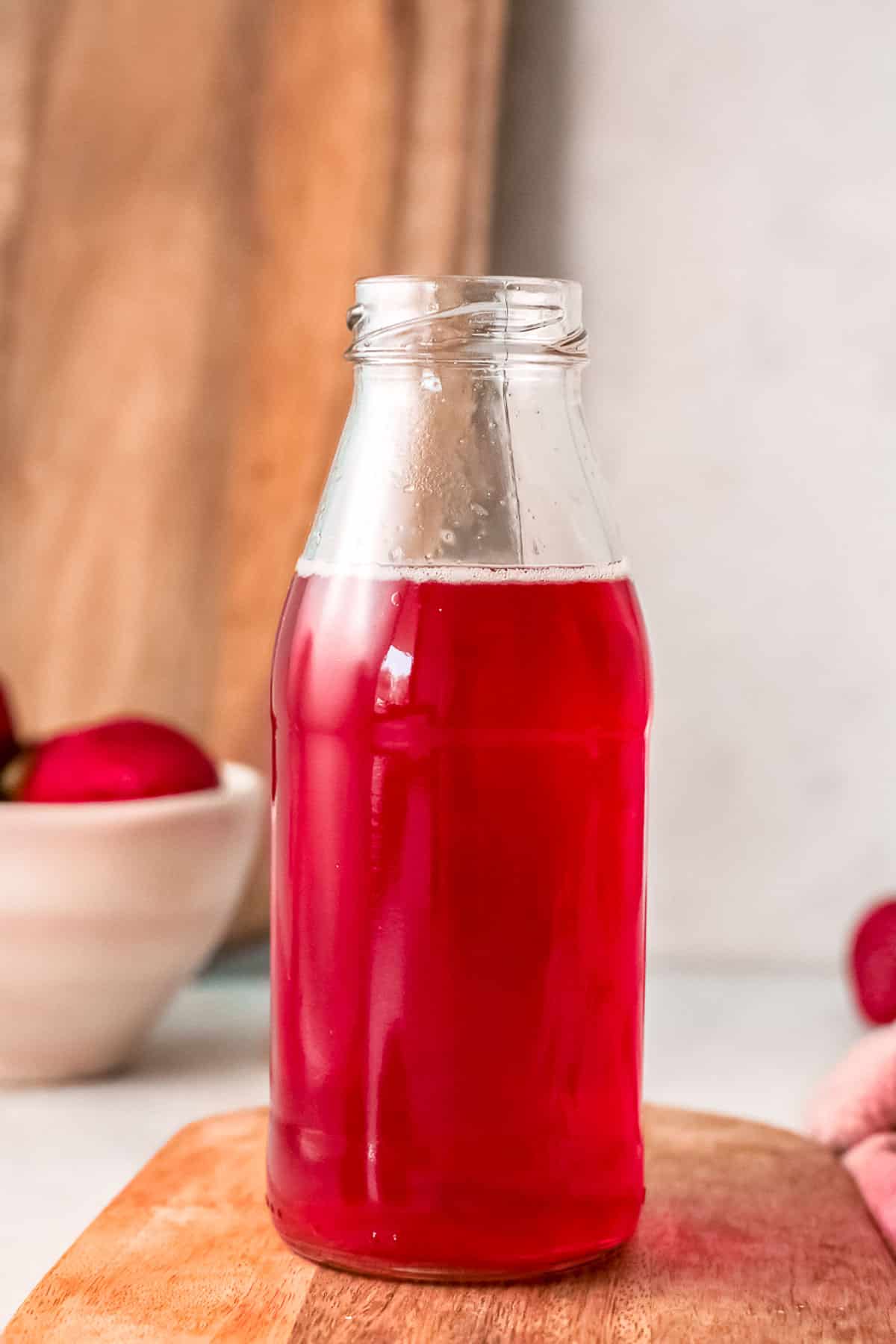 strawberry simple syrup in bottle close up