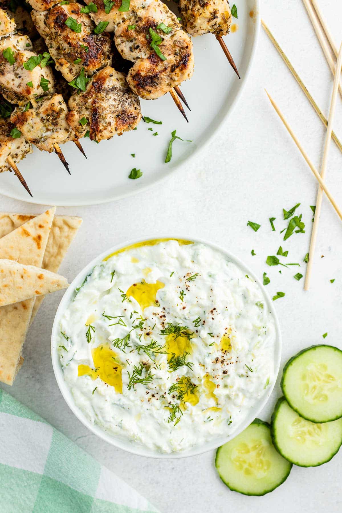 tzatziki sauce with souvlaki skewers from overhead 