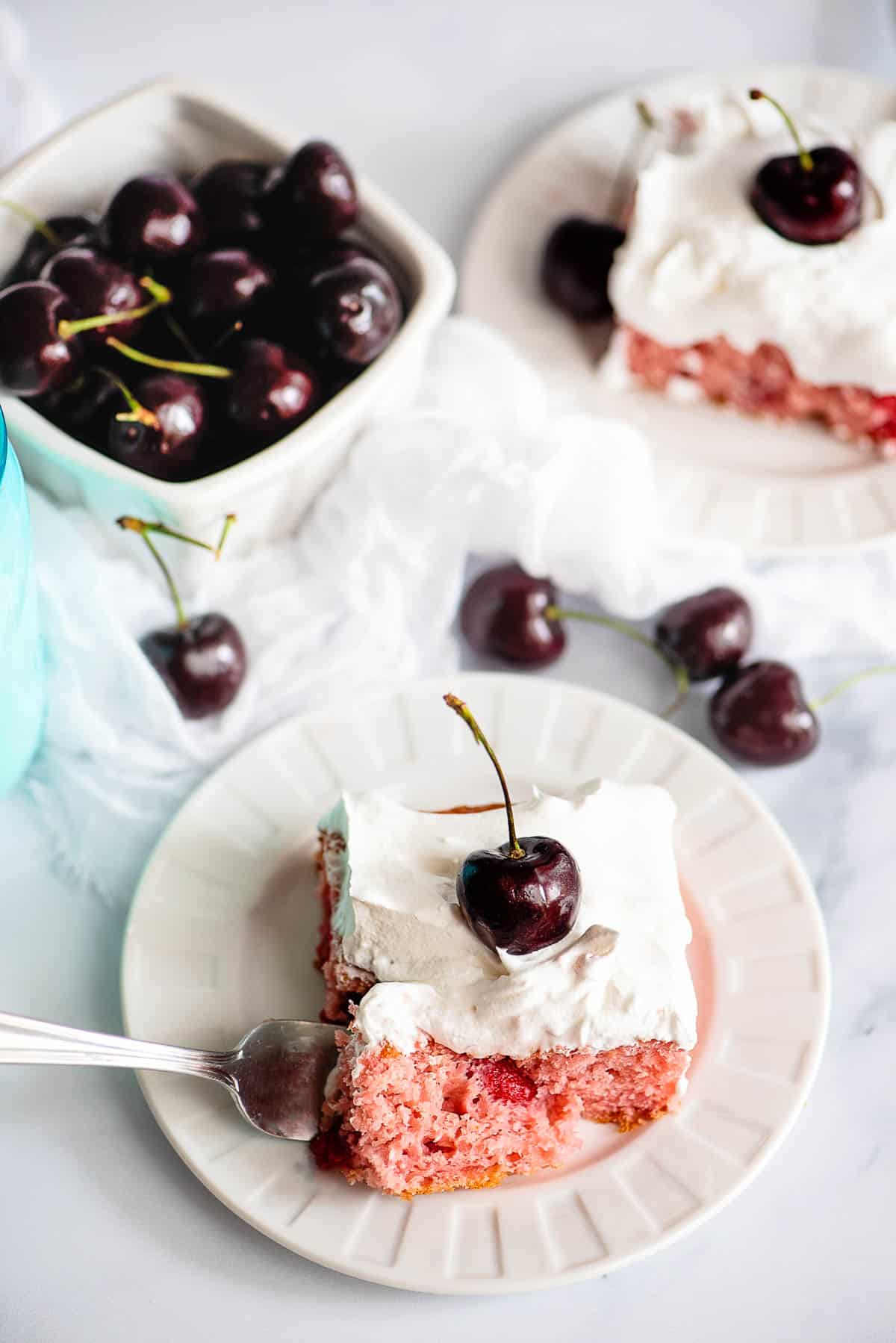 cherry cake slice with whipped cream overhead