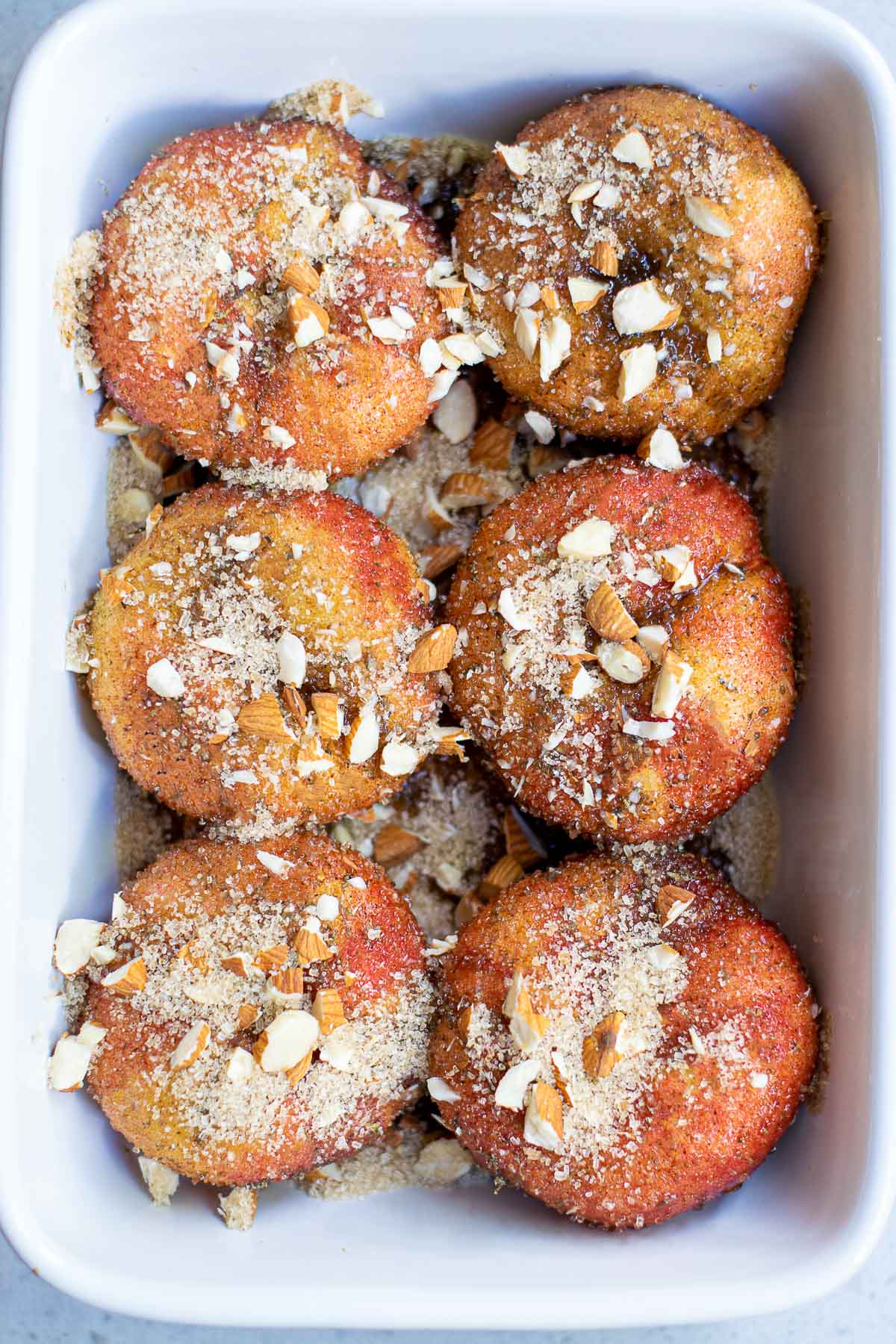 donut peaches in baking pan with nuts