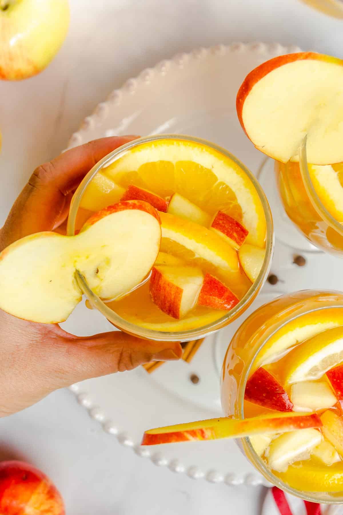 apple cider sangria in glasses from above with hand