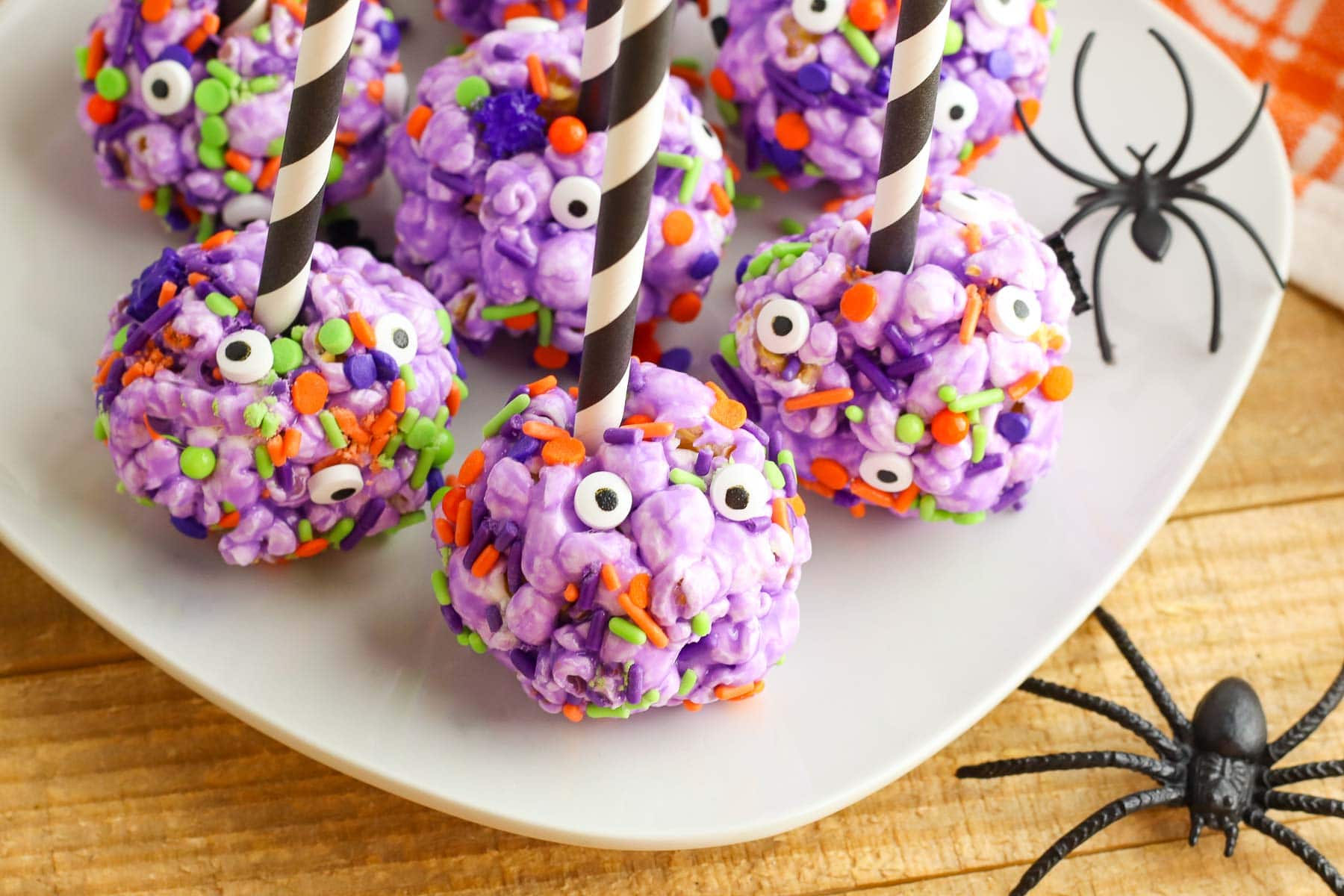 halloween popcorn balls with sticks on plate horizontal