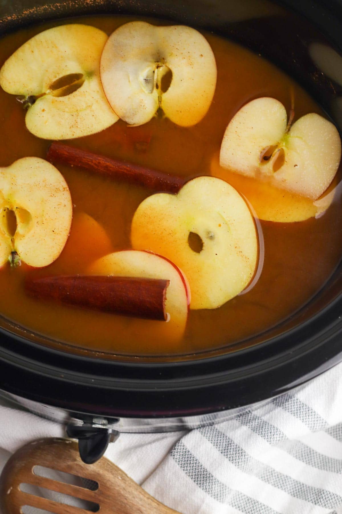 spiced apple cider with pumpkin in a slow cooker