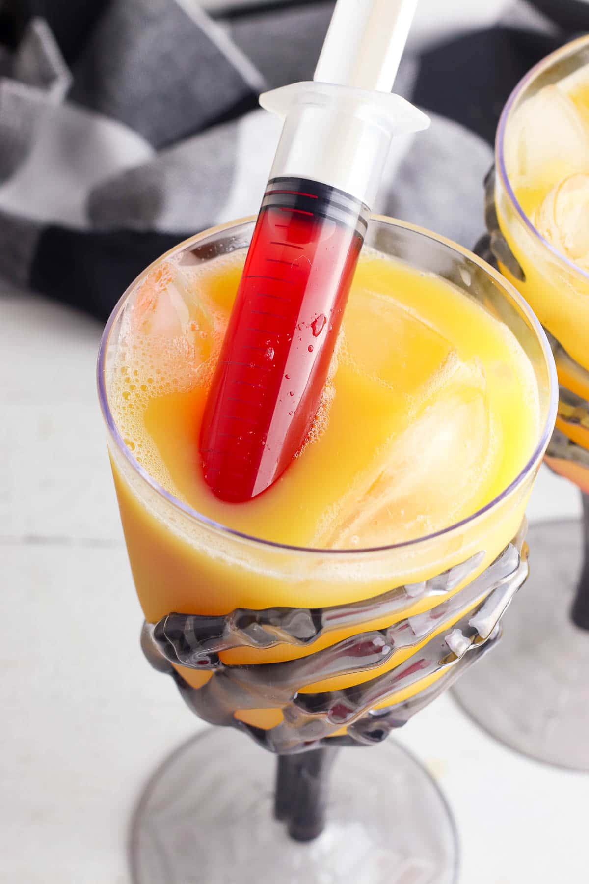 tequila sunrise cocktail with syringe 