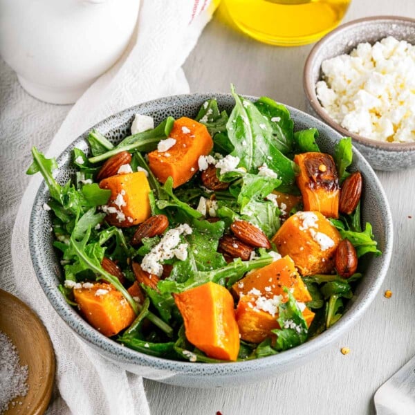 roasted pumpkin in bowl with feta and arugula