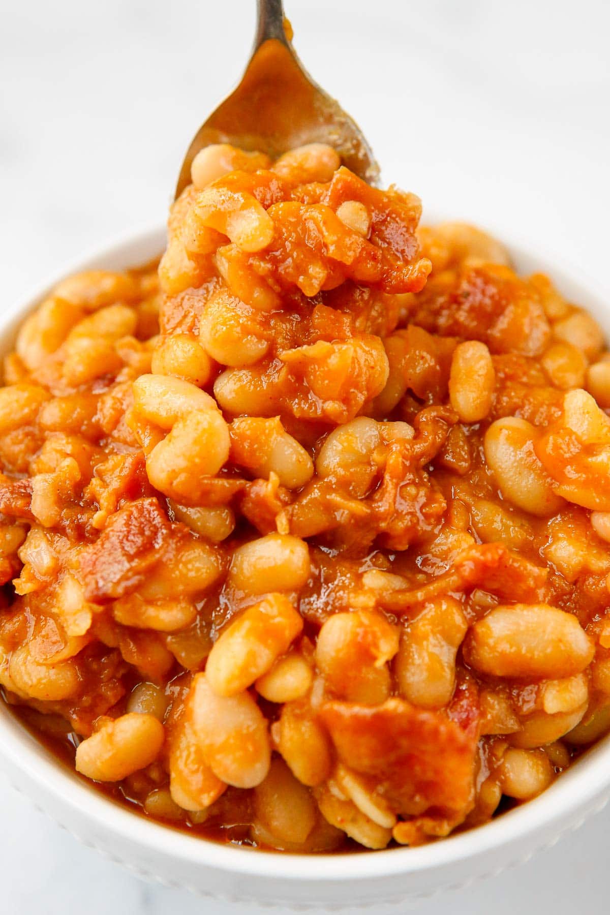 baked beans close up on spoon 