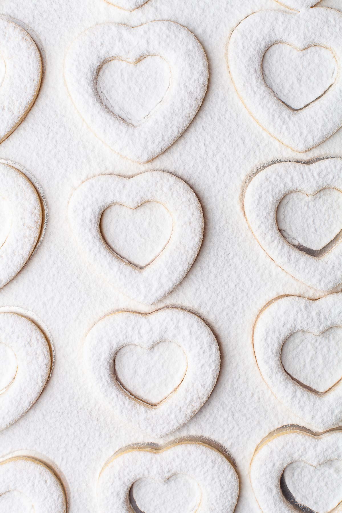 heart linzer cookies with cut outs and powdered sugar