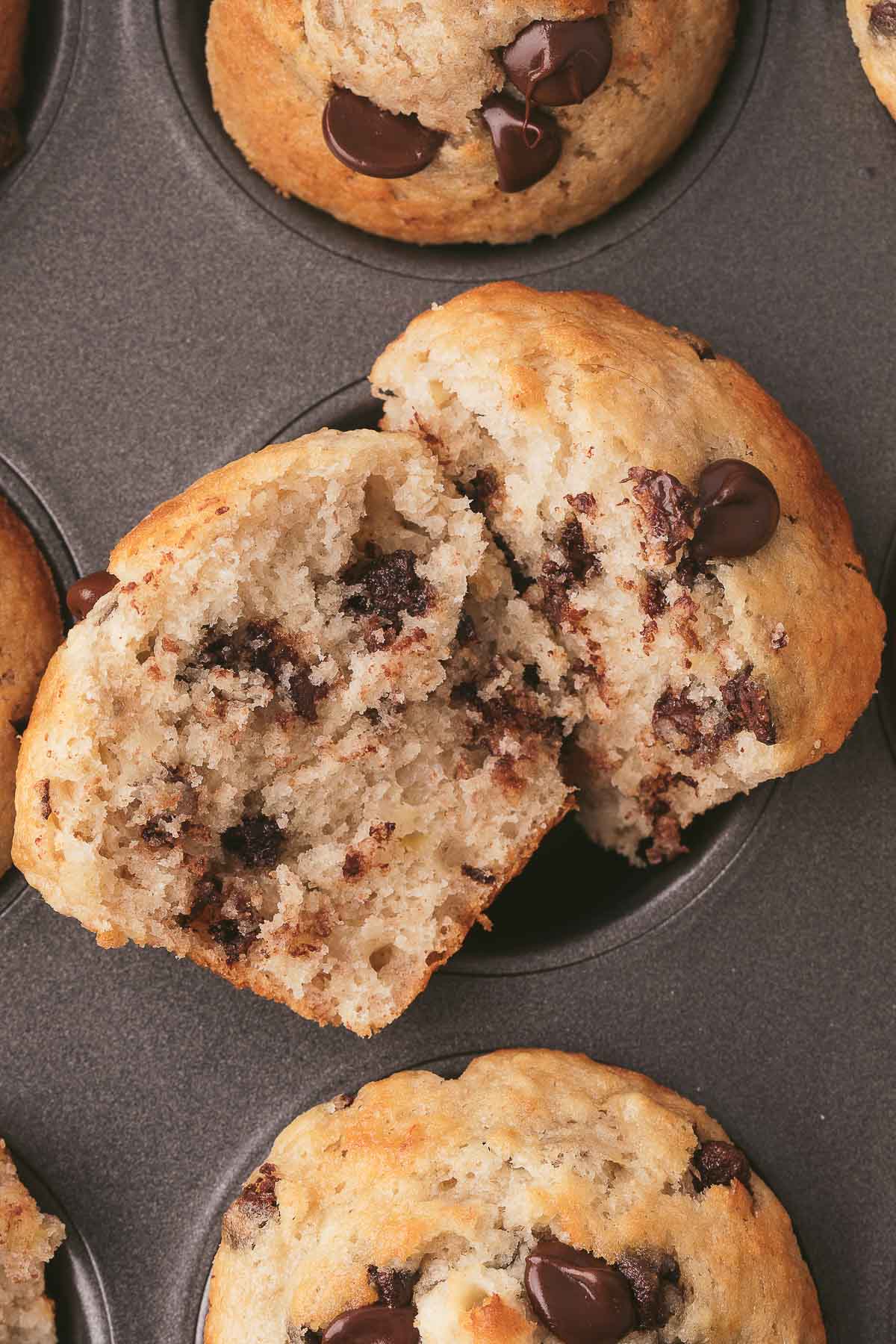 banana chocolate chip muffins in pan sliced open