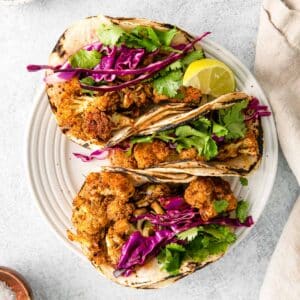 cauliflower tacos on white plate above