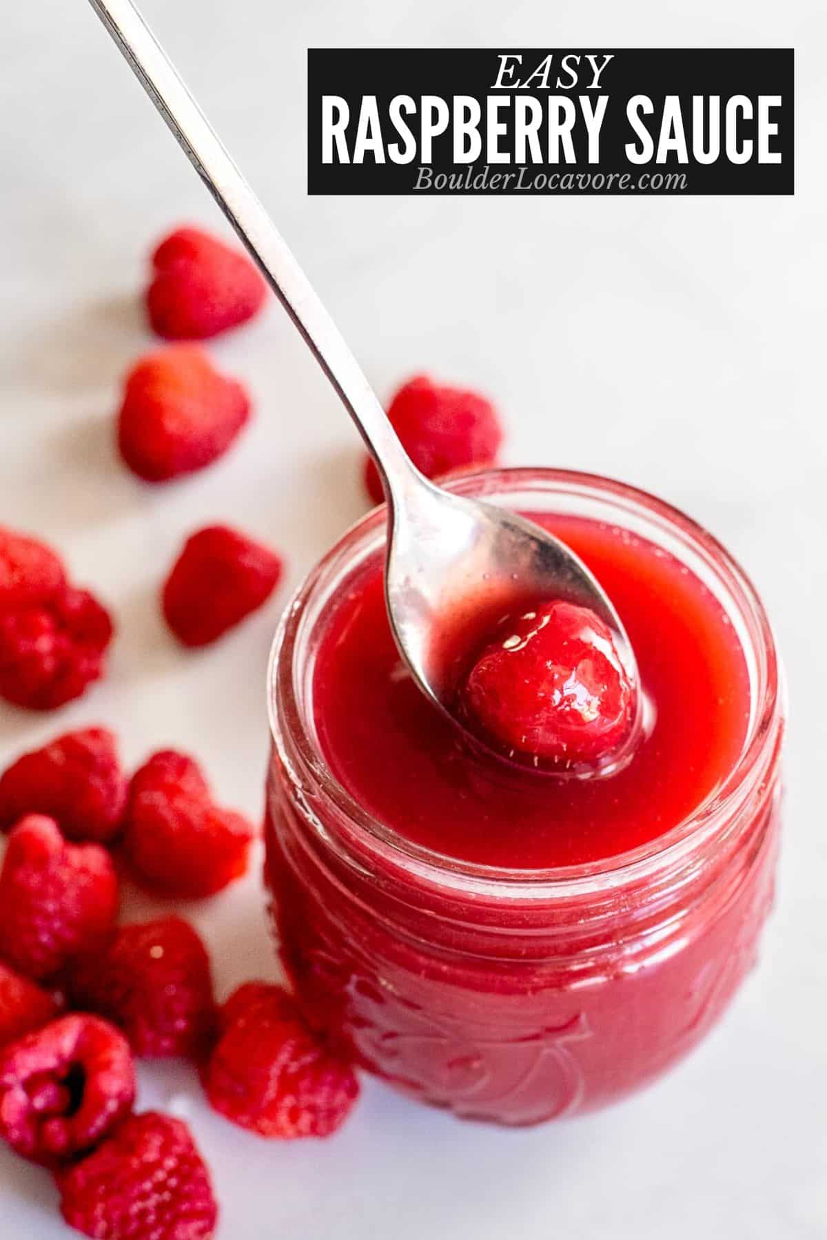 raspberry sauce in jar with spoon.