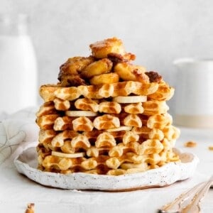 stack of homemade waffles with bananas foster topping.