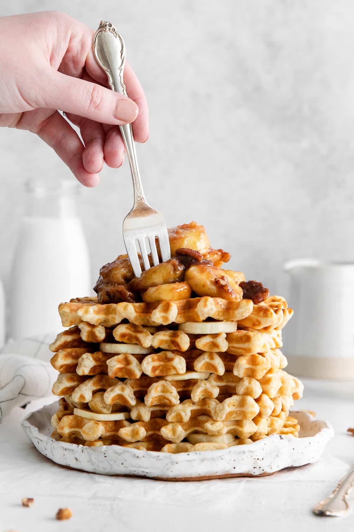 stack of waffles with bananas foster topping.