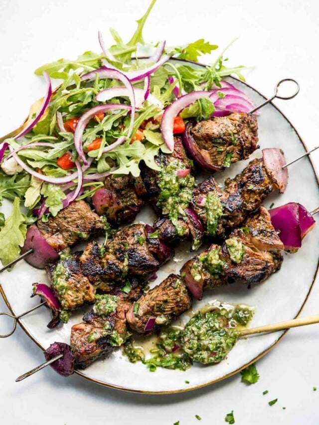 cropped-chimichurri-steak-skewers-on-plate-with-salad-overhead.jpg