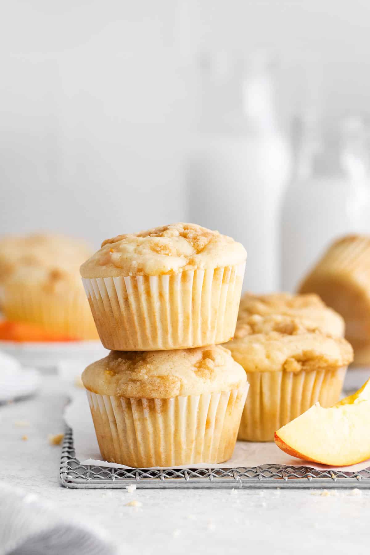 peach muffins on wire rack side view.
