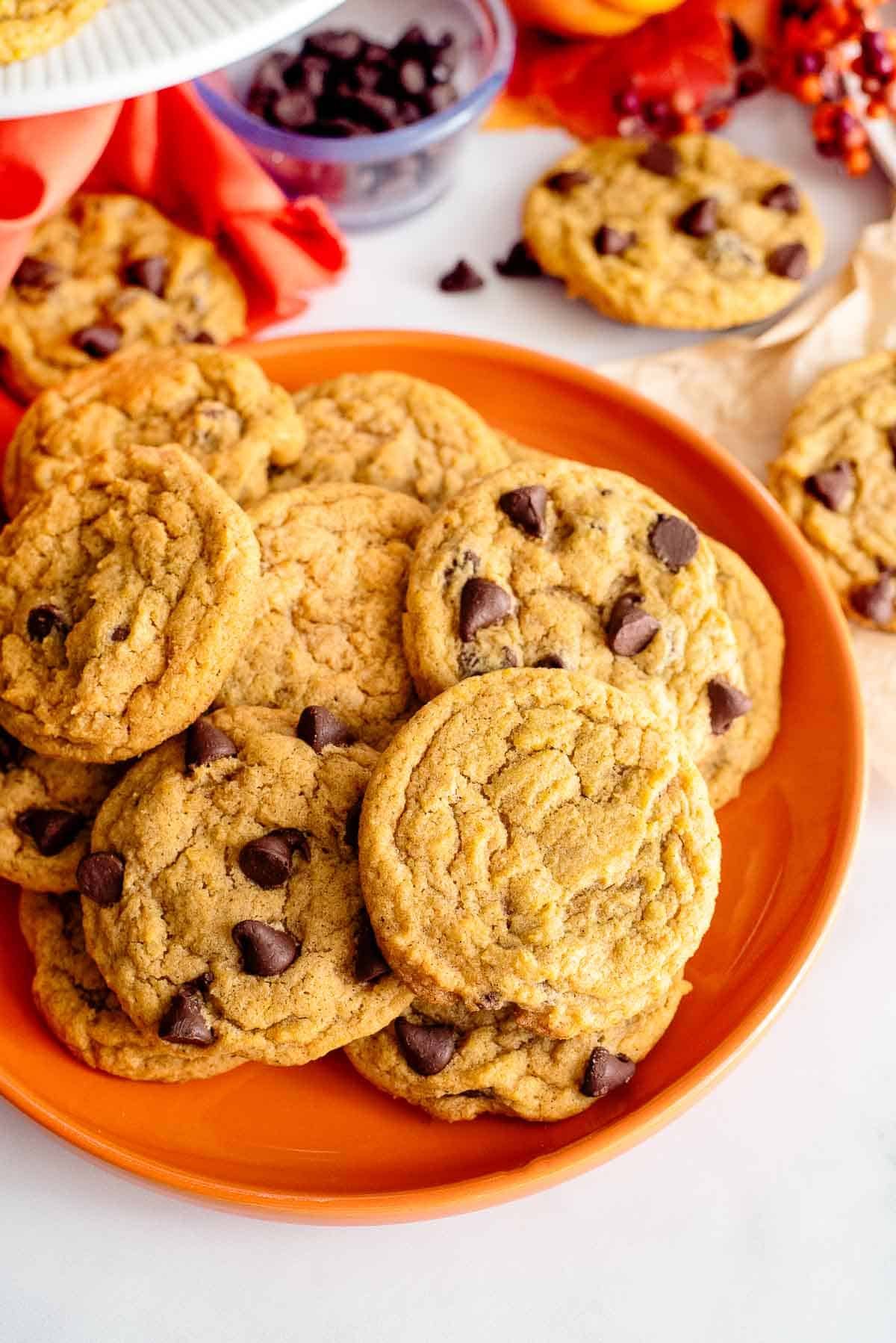 pumpkin chocolate chip cookies on a plate.