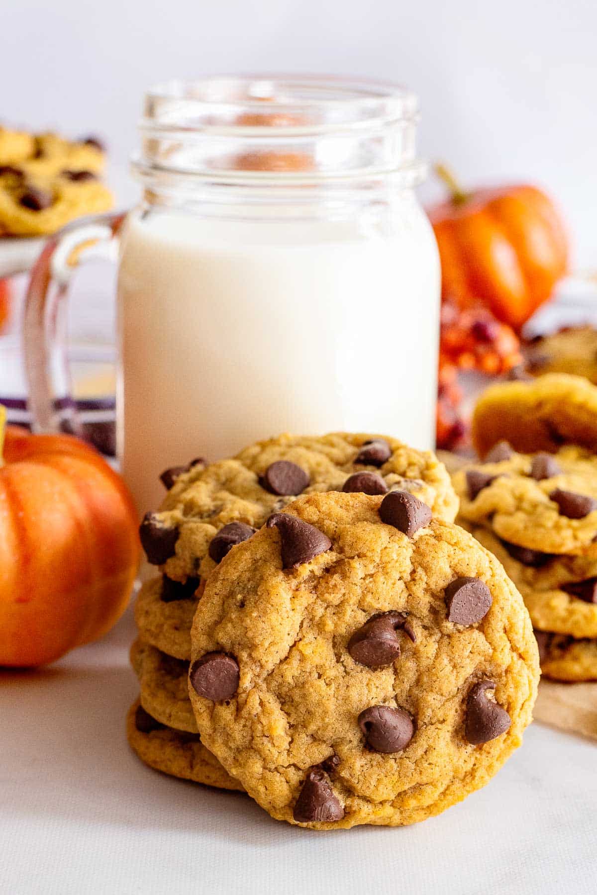 pumpkin chocolate chip cookies with glass of milk.