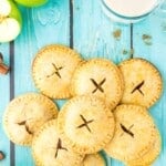 apple hand pies on blue wood stacked.