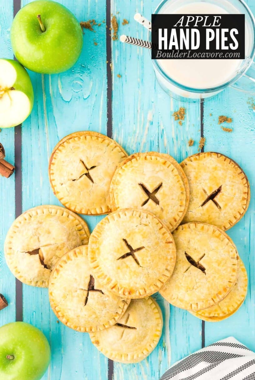 apple hand pies on blue wood stacked.