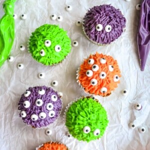 monster cupcakes of different colors with candy eyes.