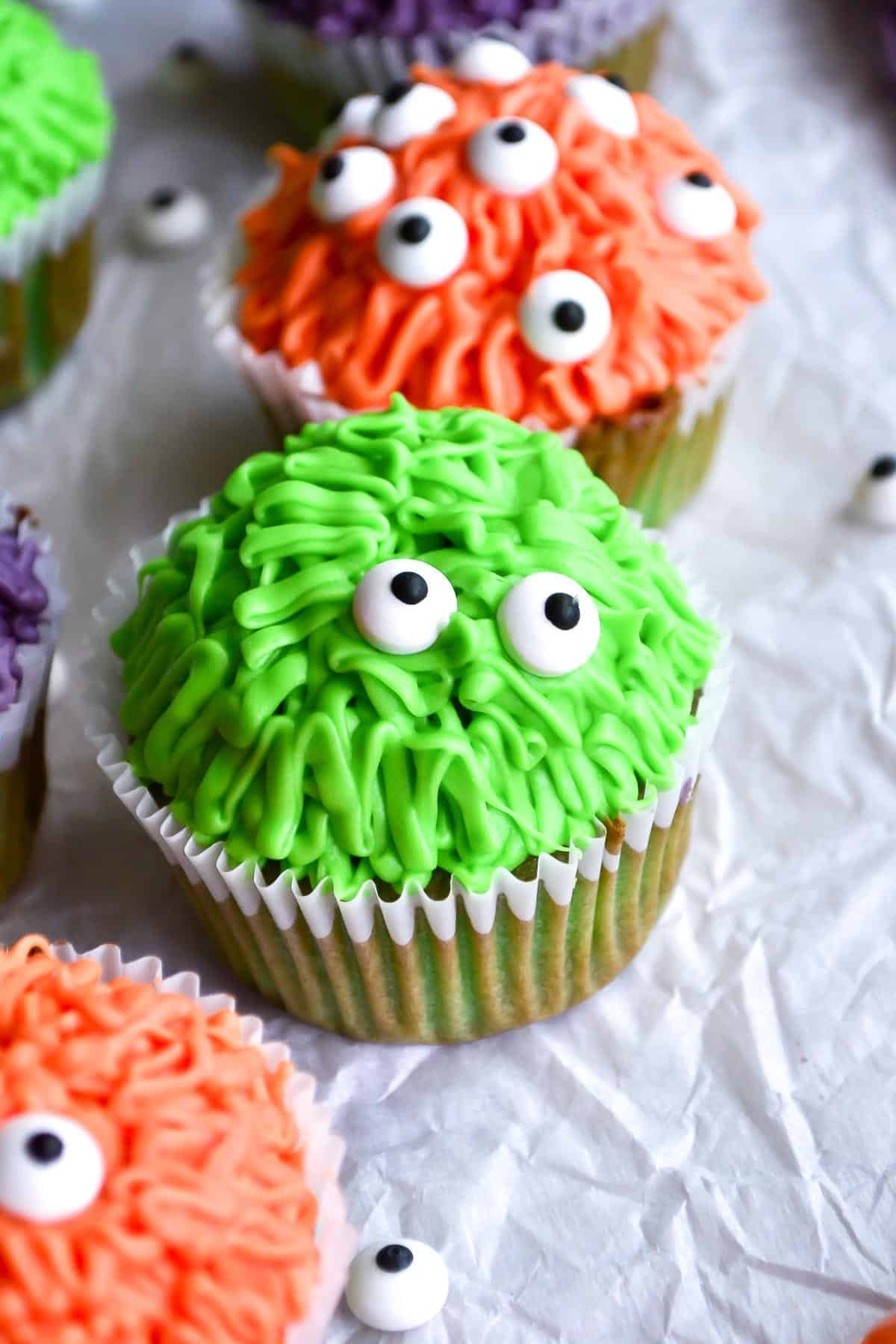 monster cupcakes with orange frosting fur.