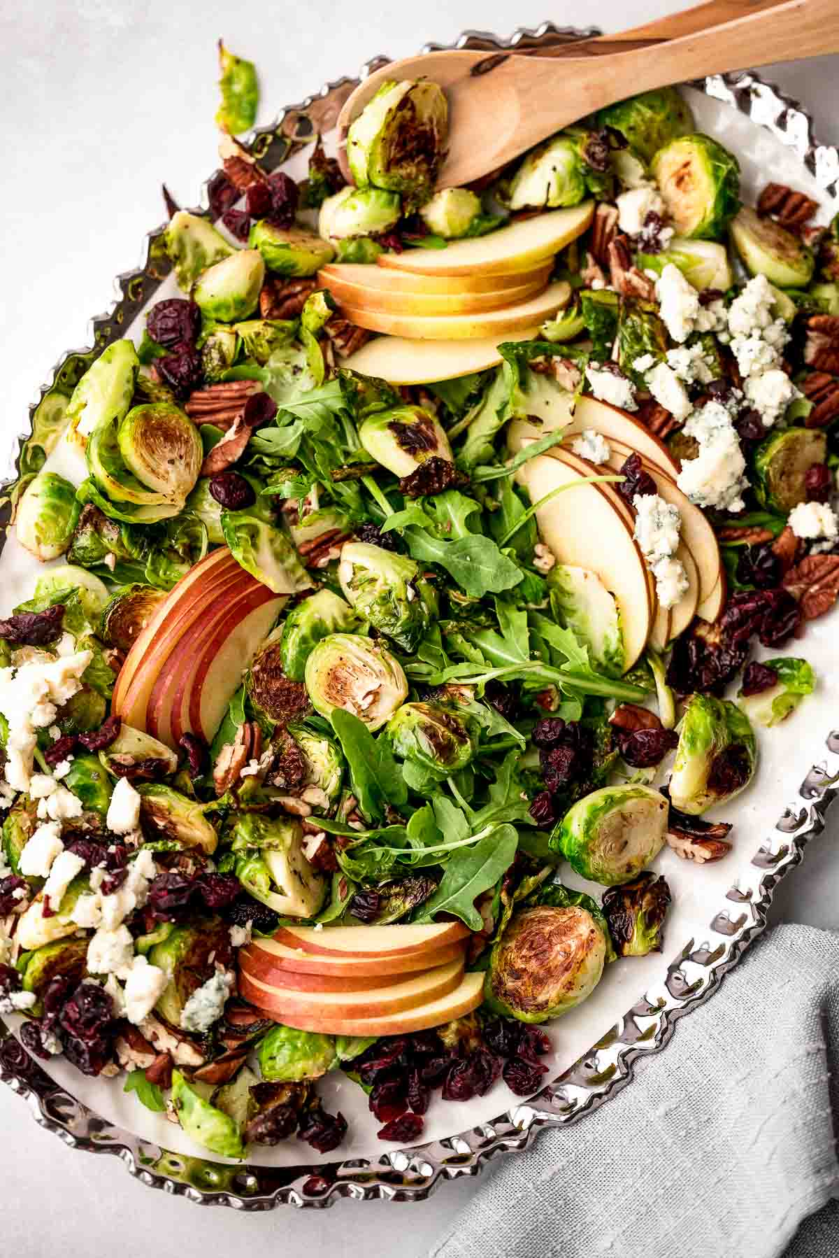 roasted brussels sprouts salad overhead with tongs.