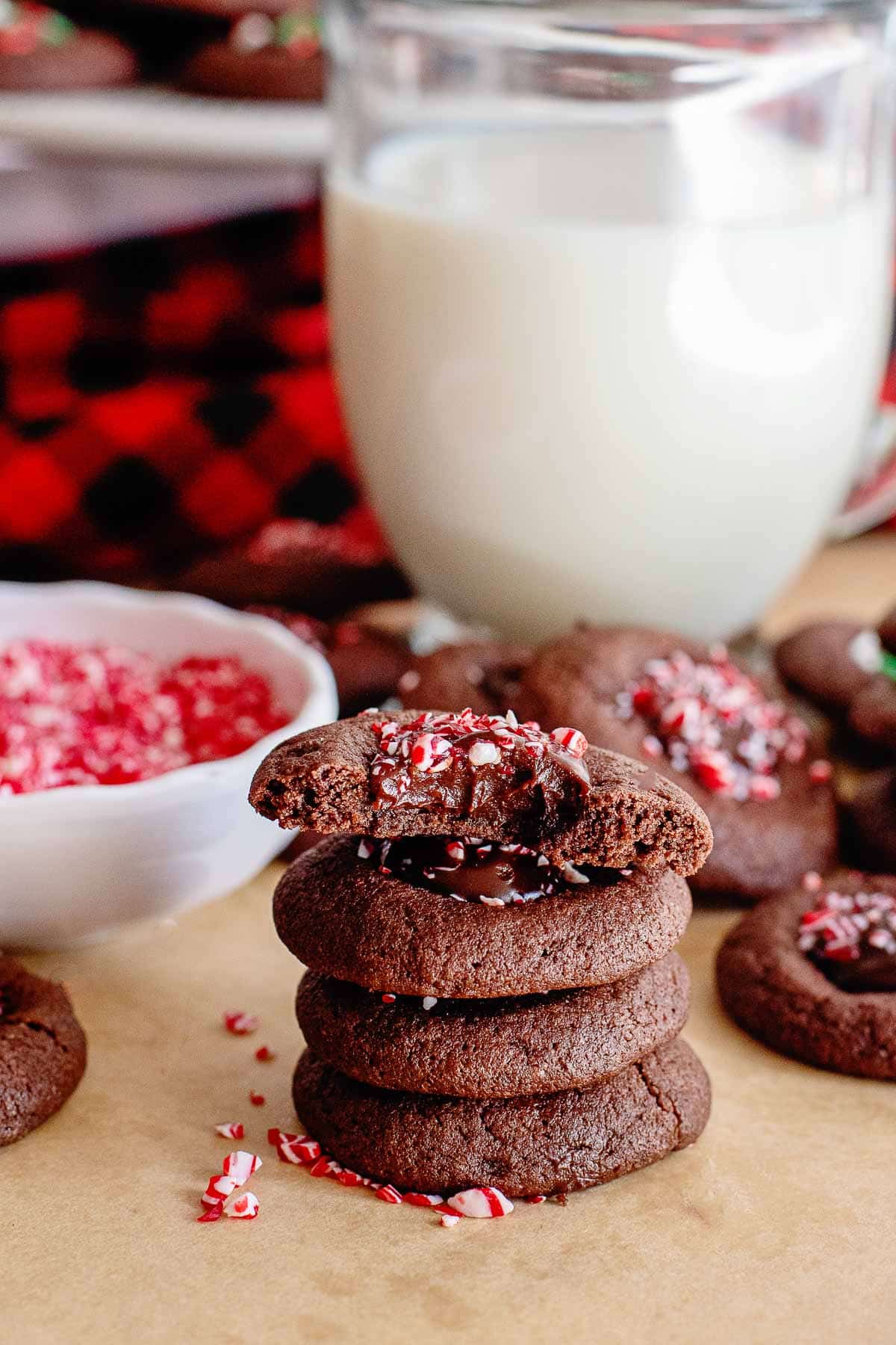 chocolate thumbprint cookies with peppermint topping stacked.