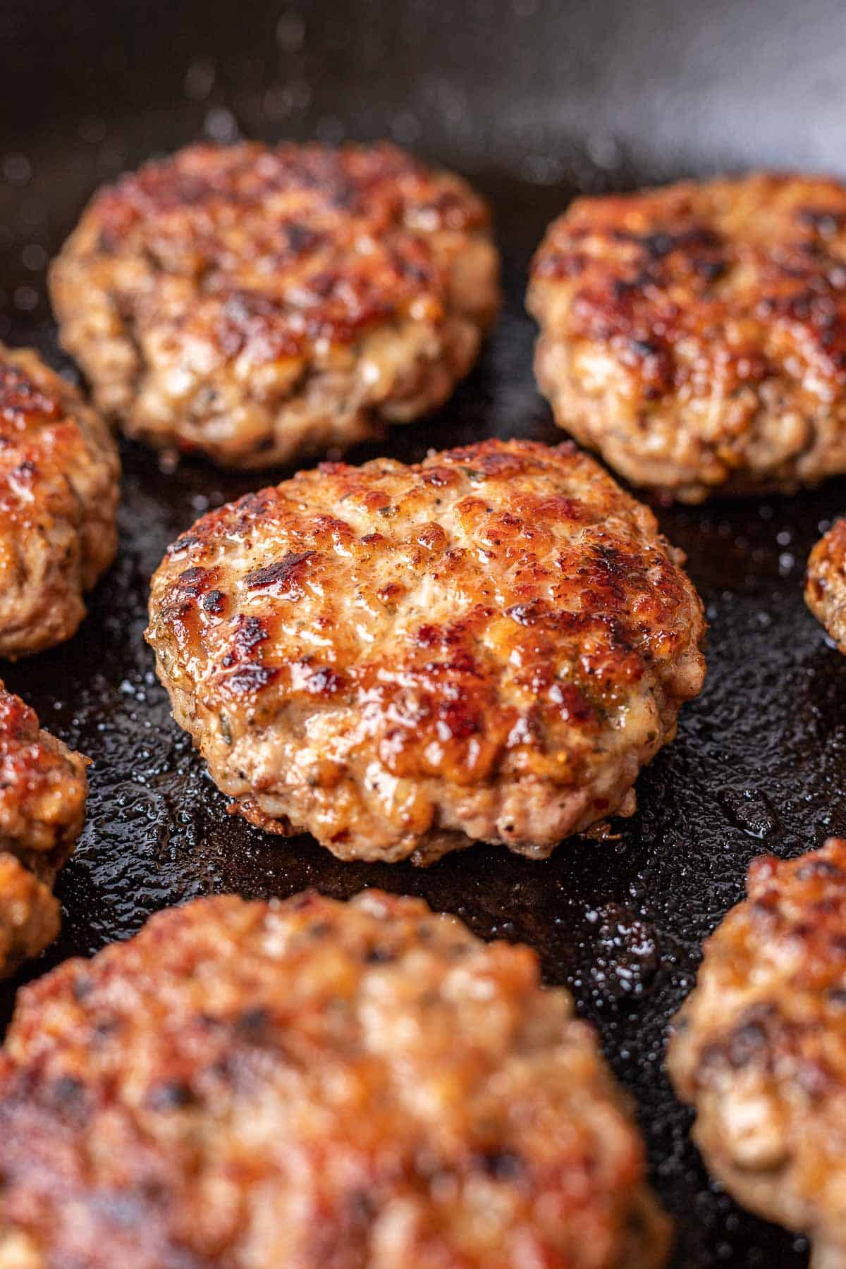 cooked homemade breakfast sausage in skillet close up.