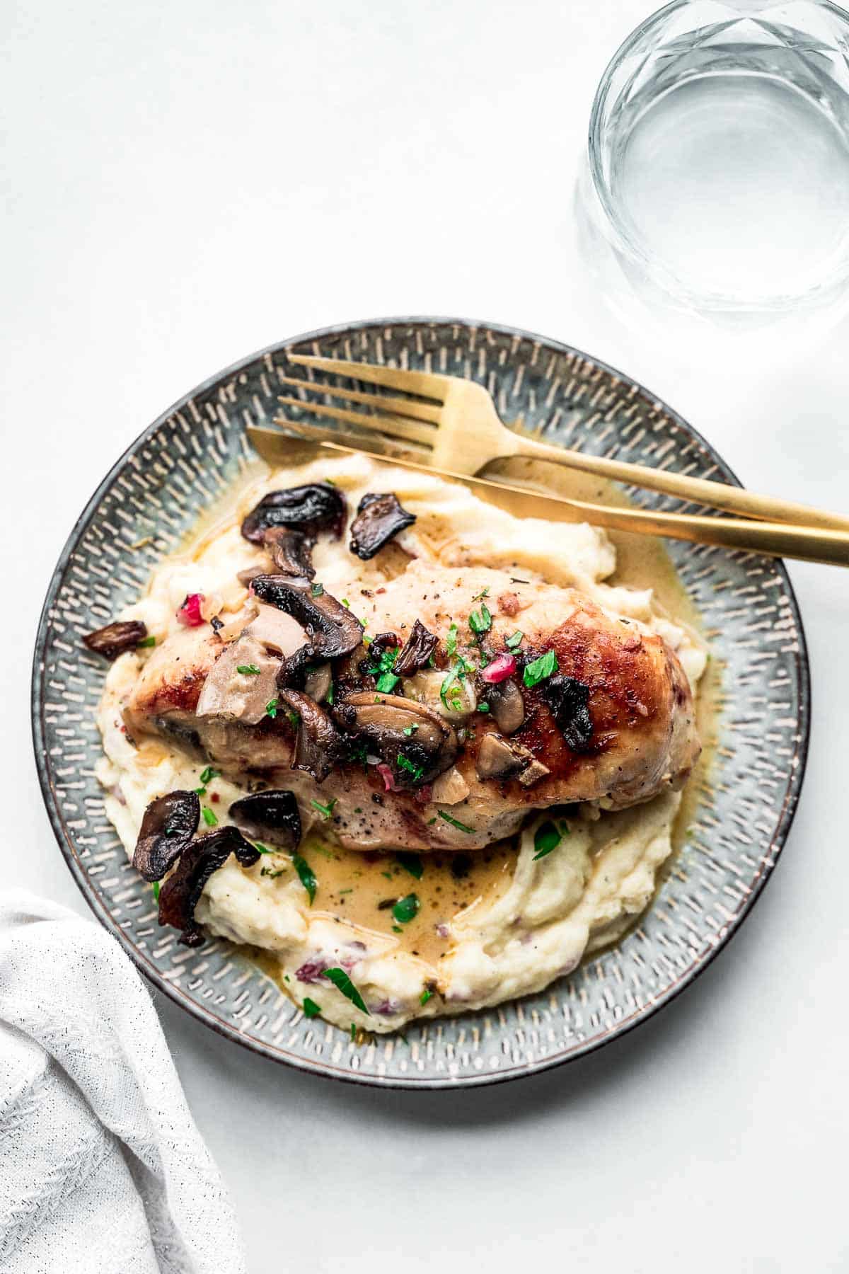 mushroom chicken with mashed potatoes on plate.
