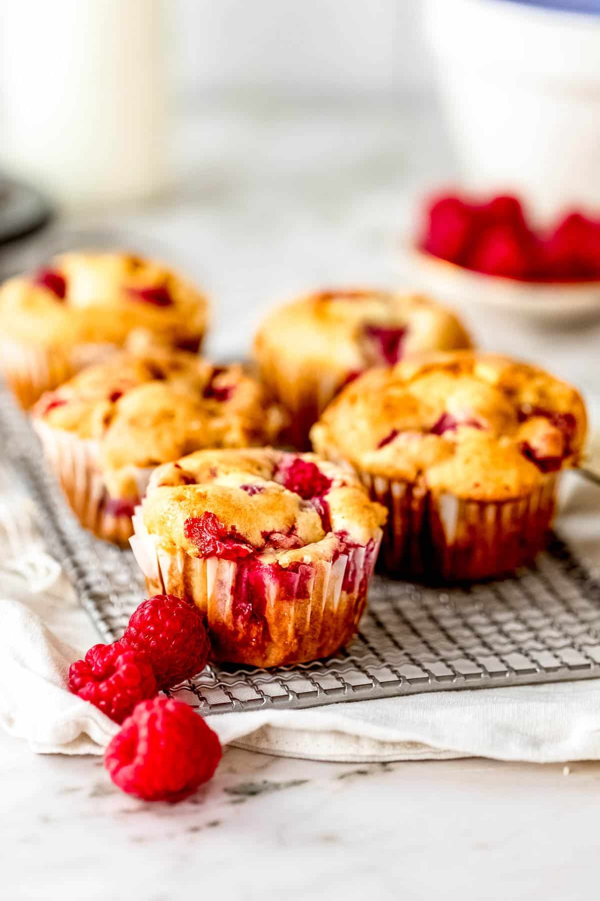 white chocolate raspberry muffins on cooling rack .