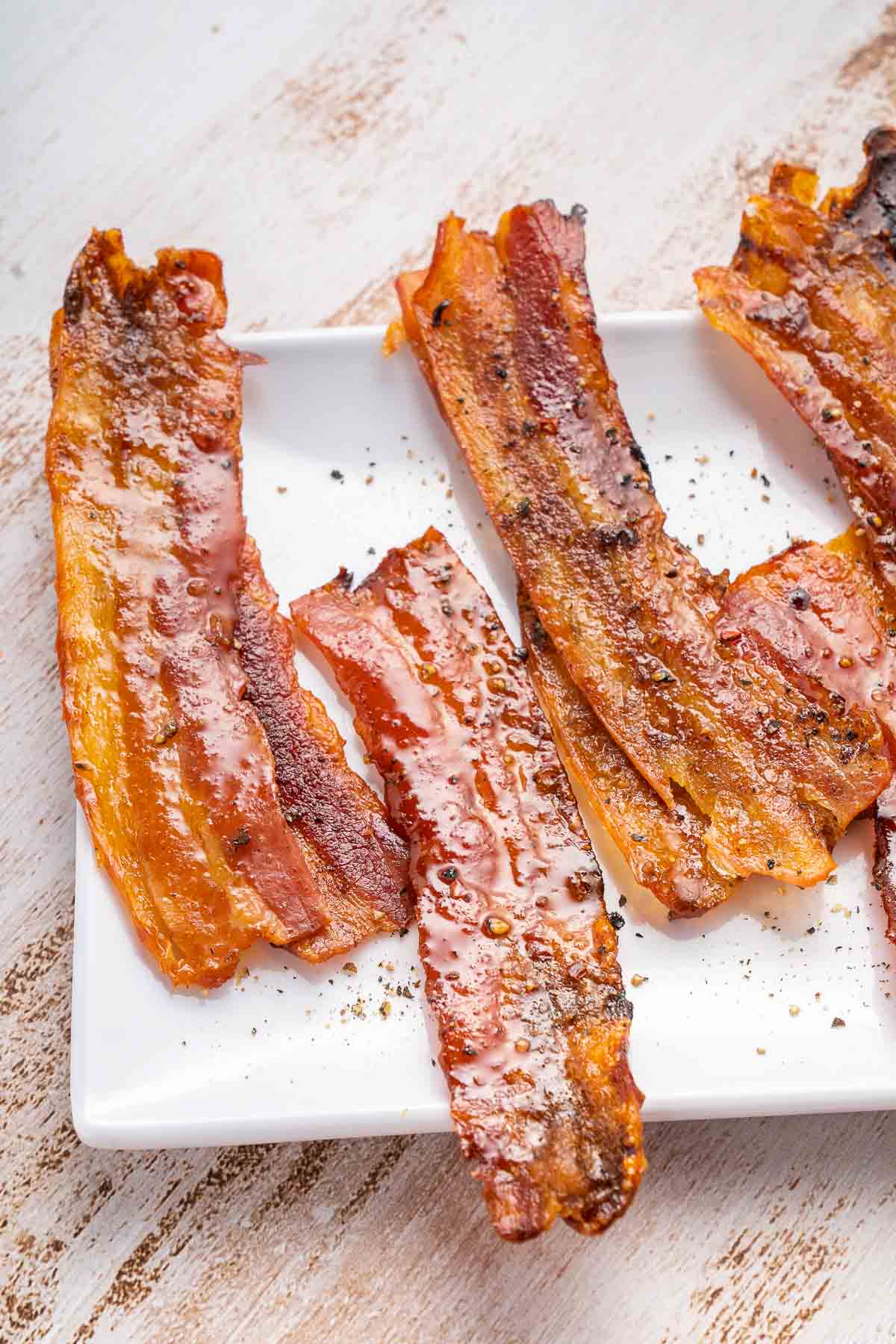 candied bacon on plate side.