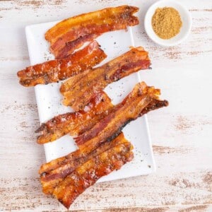 candied bacon on white plate crop.
