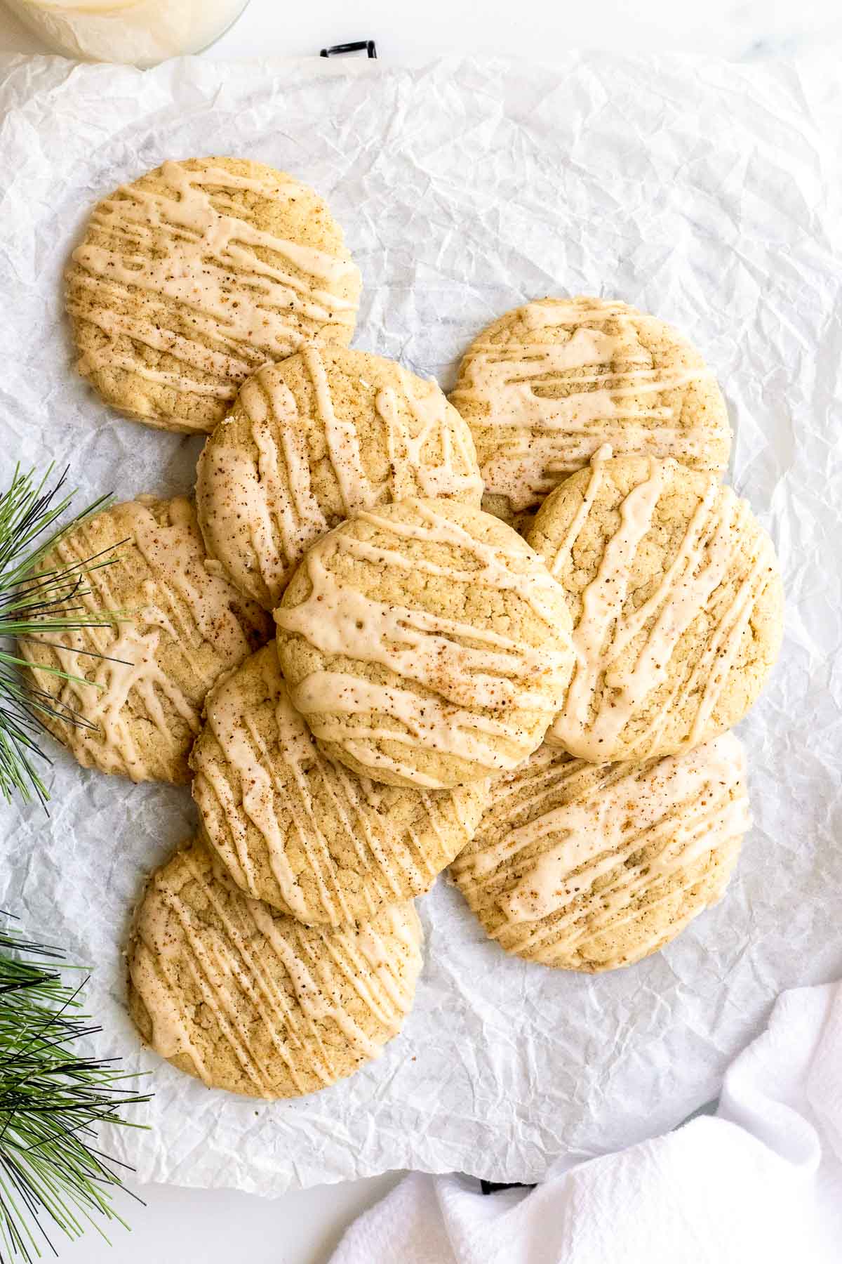 eggnog cookies stacked on tissue paper.