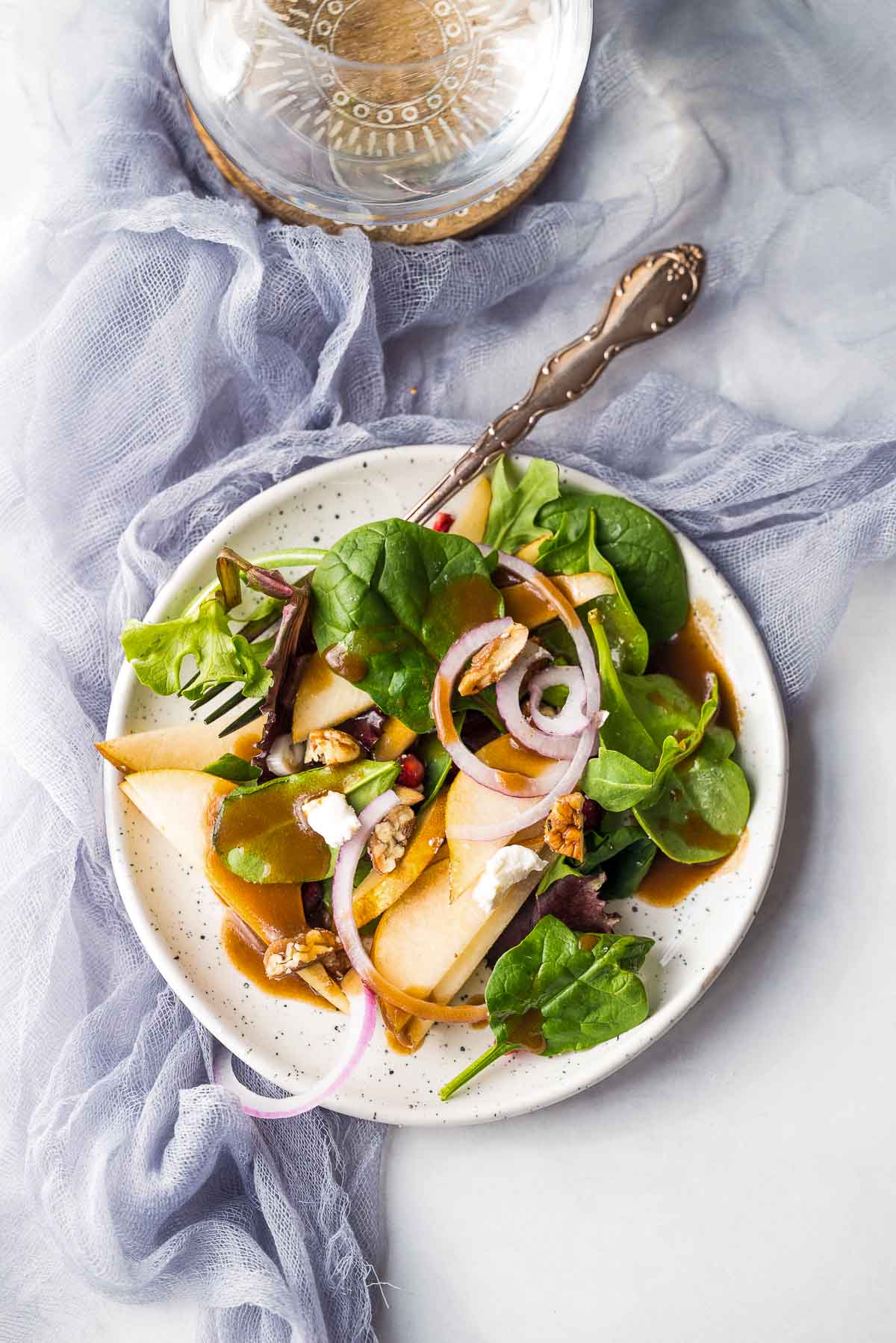 pear salad with dressing on plate.