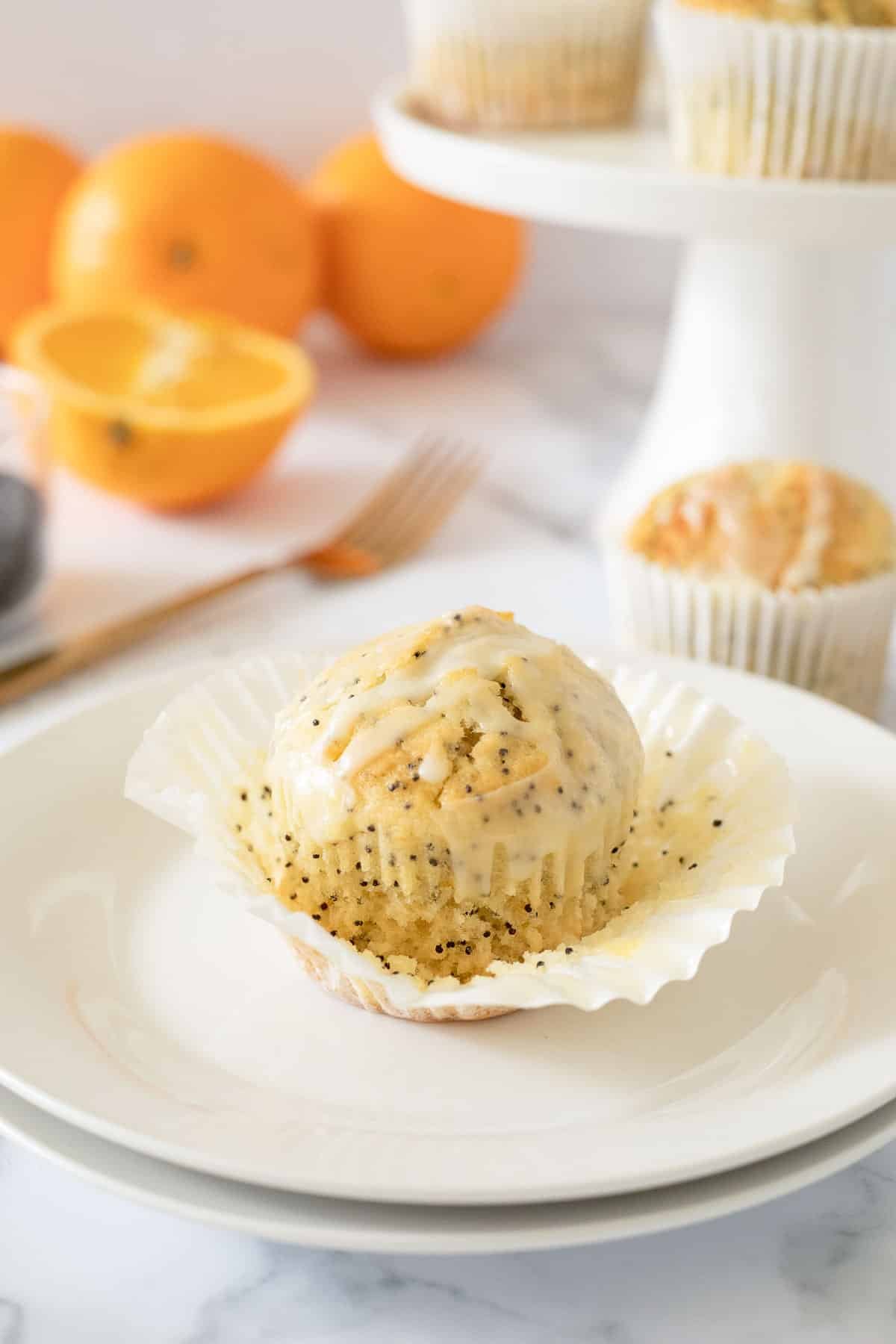 orange poppy seed muffin on white plate.