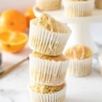 orange poppy seed muffins in a stack.