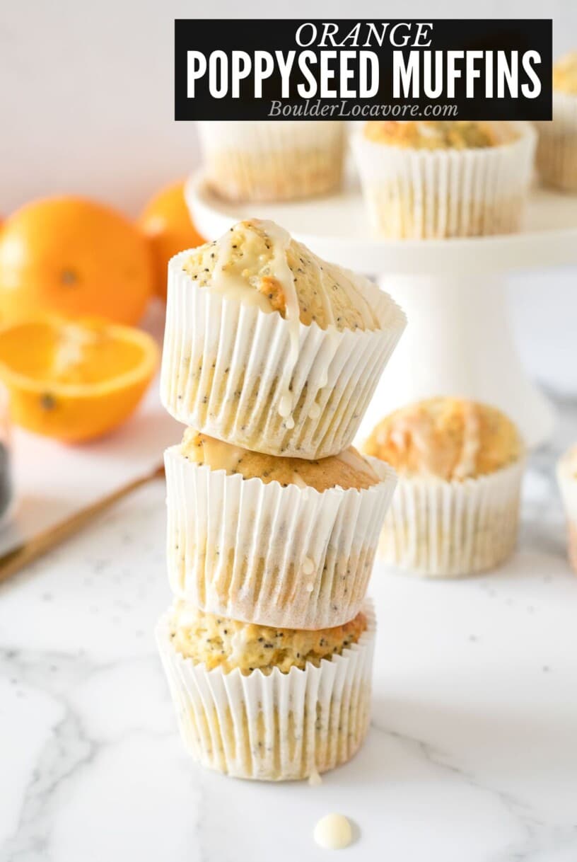 orange poppy seed muffins in a stack.