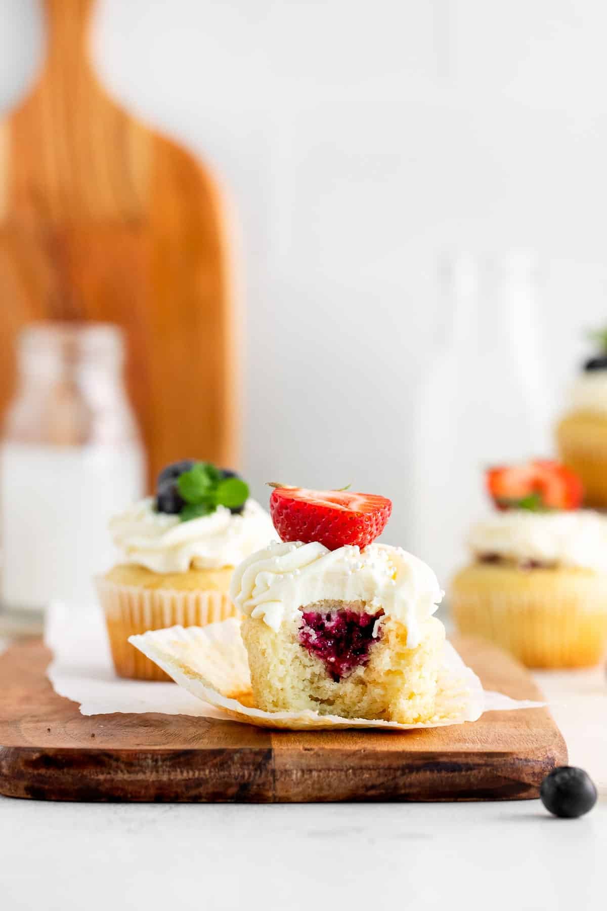 vanilla cupcakes mascarpone frosting side with bite out