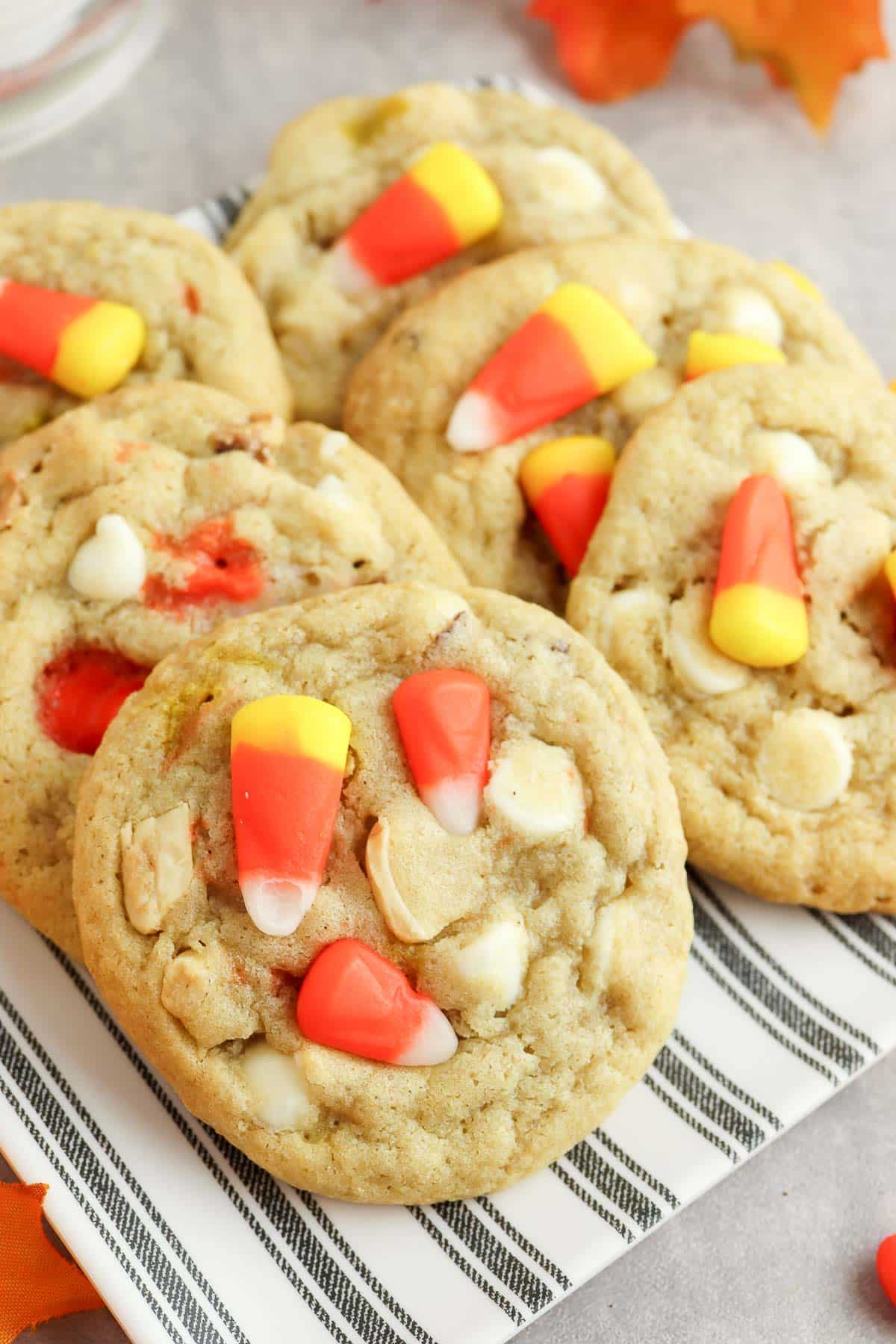 candy corn cookies on plate on striped plate.