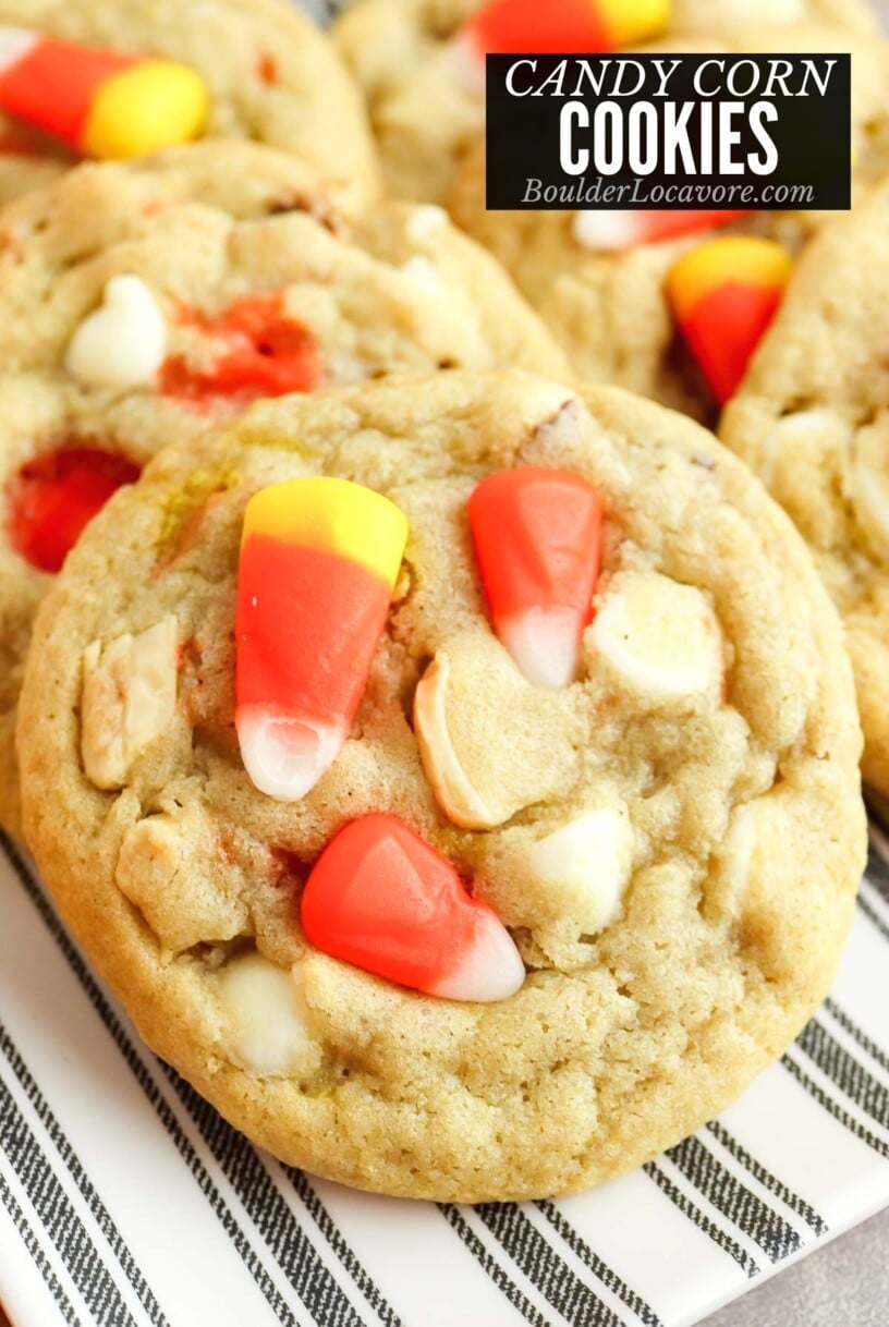 candy corn cookies on striped plate.