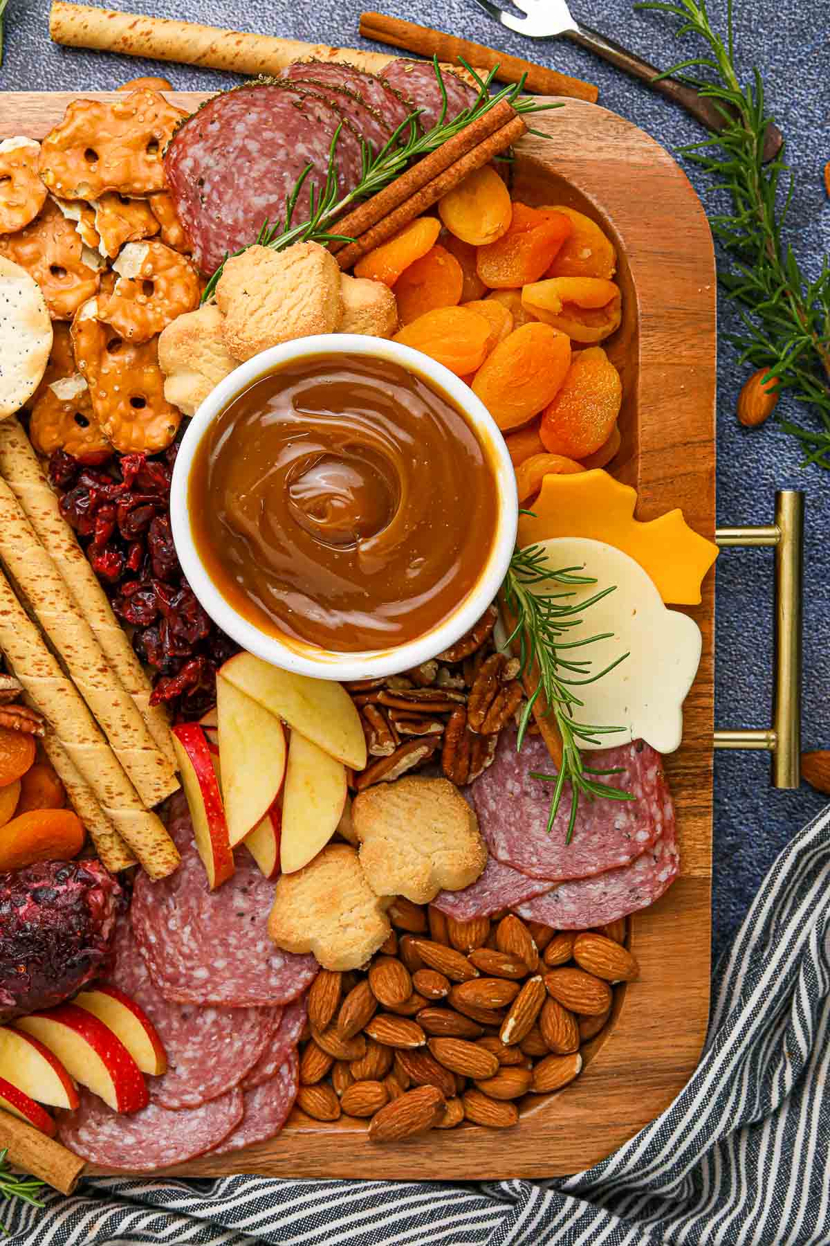 fall charcuterie board ingredients on board cheese and nuts.