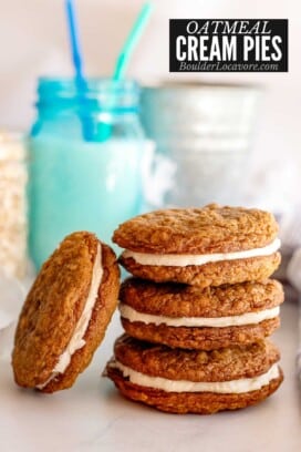 oatmeal cream pies stacked with blue glass of milk.