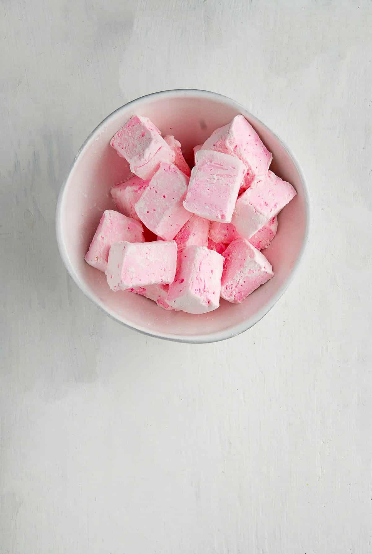 rose flavored homemade marshmallows in blue bowl.