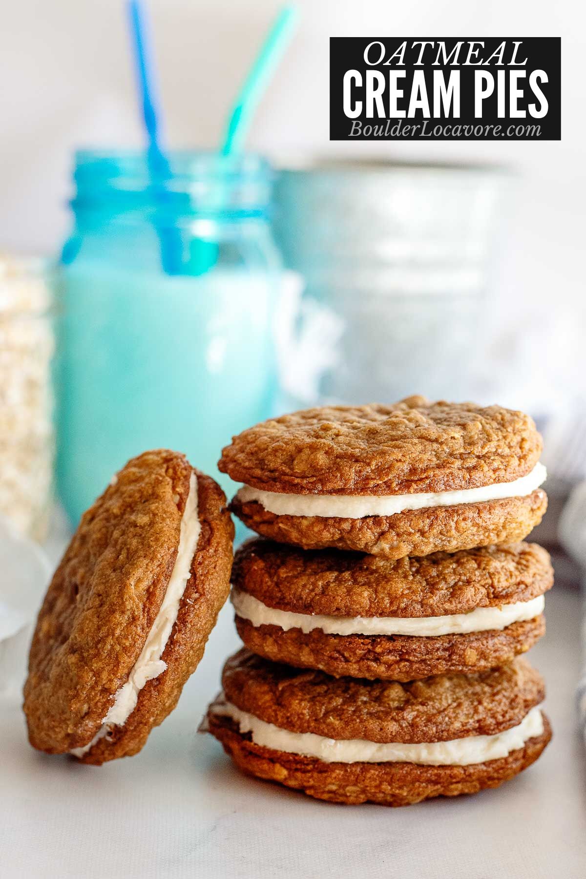 stacked oatmeal cream pies with blue jar of milk.