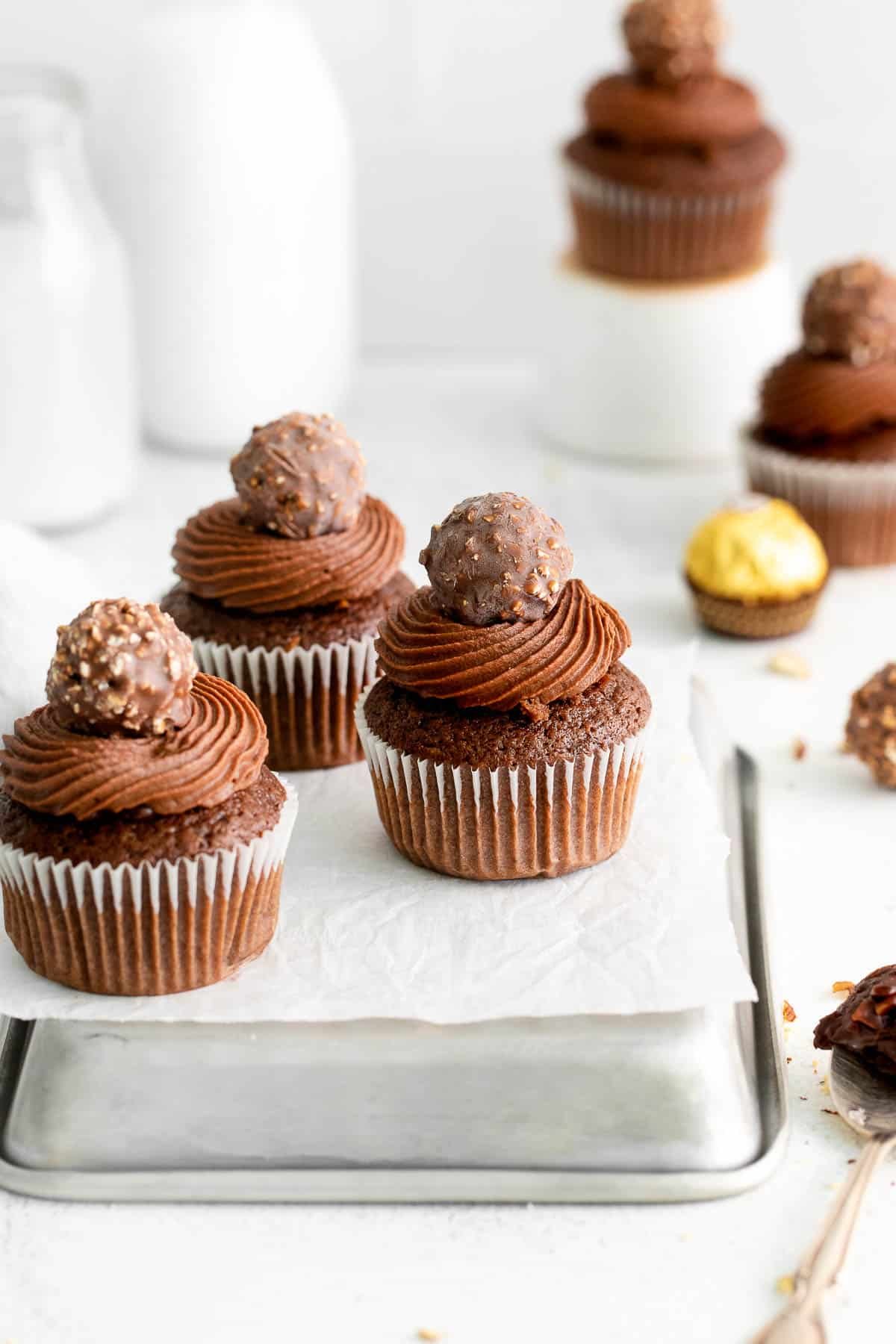 ferrero rocher cupcakes on a metal baking sheet overhead.