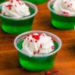 grinch jello shots on wooden cutting board