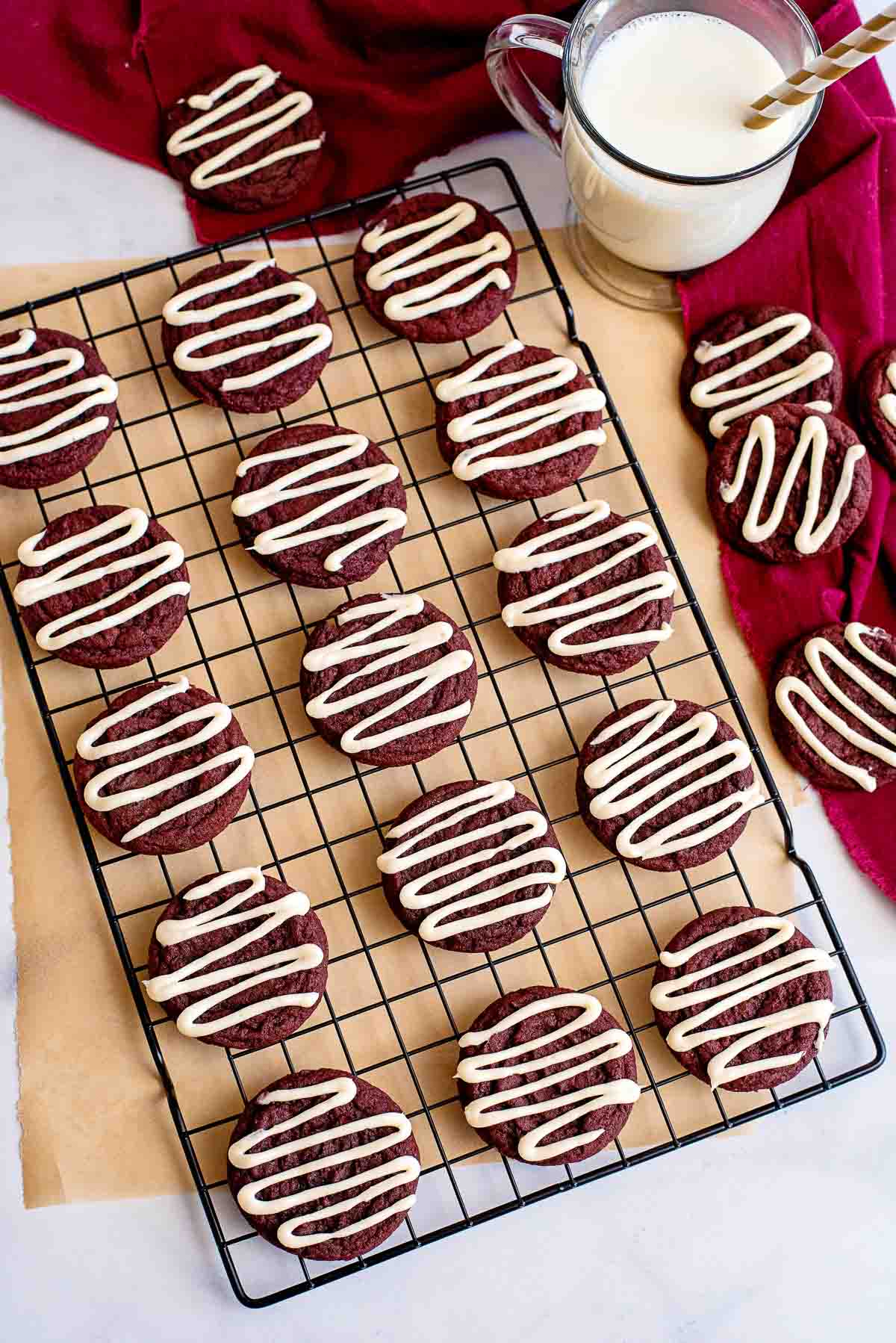 red velvet cookies glazed on cooling rack.
