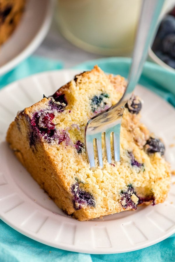 fork in a slice of blueberry coffee cake