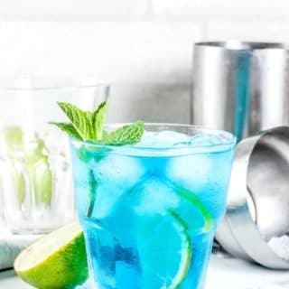 Blue Margarita in glass with ice with title